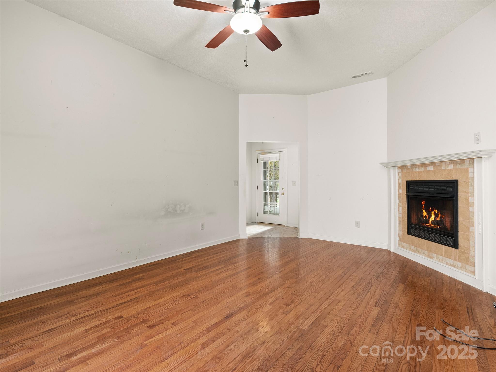 83 Indian Trace Road Maggie Valley, NC 28751 - Photo 4 of 21 wooden floor in an empty room with a fireplace