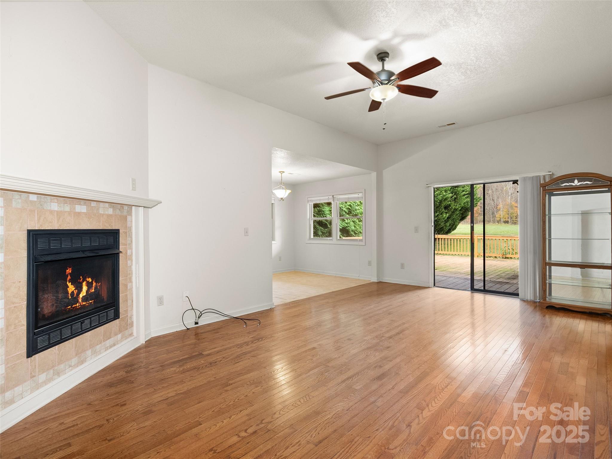 83 Indian Trace Road Maggie Valley, NC 28751 - Photo 5 of 21 a view of an empty room with window and wooden floor