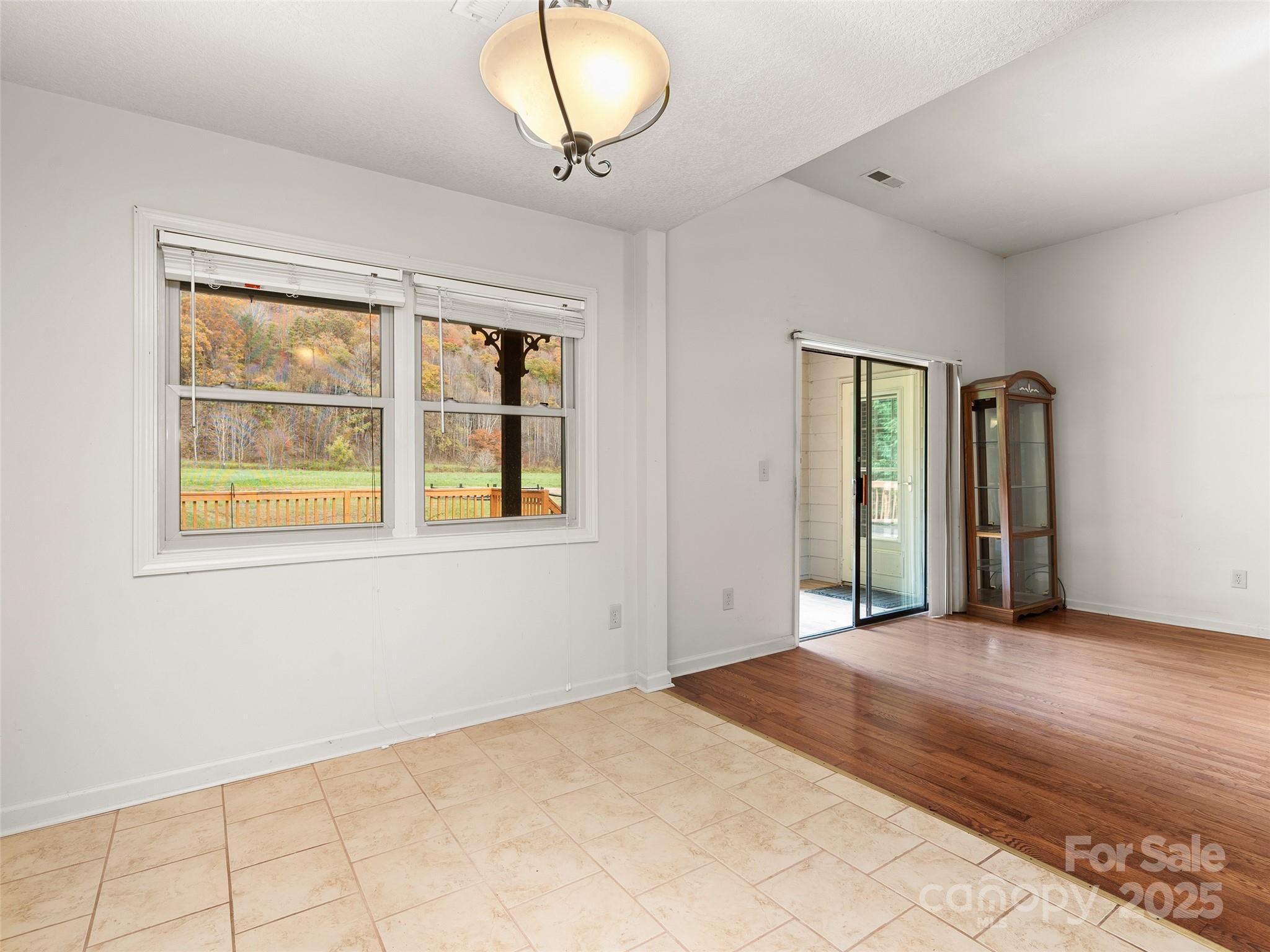 83 Indian Trace Road Maggie Valley, NC 28751 - Photo 9 of 21 a view of an empty room with window and wooden floor