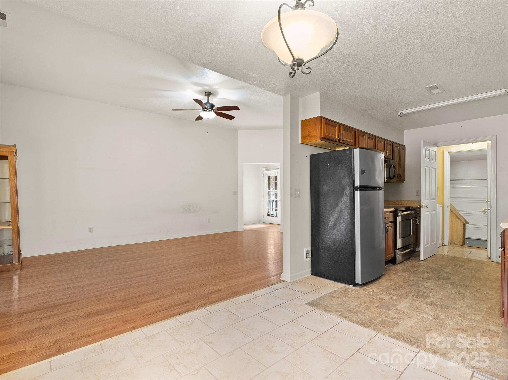 83 Indian Trace Road Maggie Valley, NC 28751 - Photo 10 of 21 a view of a livingroom with a chandelier furniture and a ceiling fan