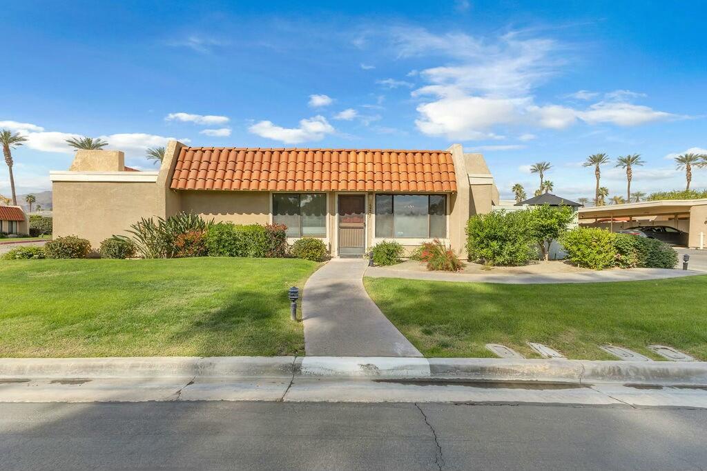 69527 Huerta Court Rancho Mirage, CA 92270 - Photo 1 of 22 a view of a house with a yard