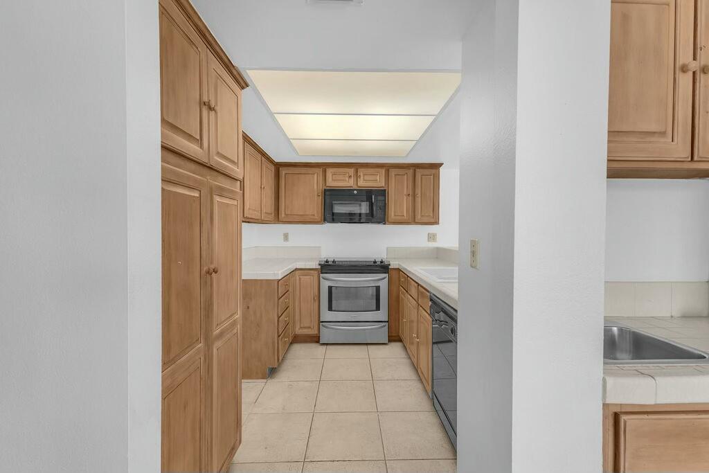 69527 Huerta Court Rancho Mirage, CA 92270 - Photo 7 of 22 a kitchen with granite countertop a sink and stove top oven