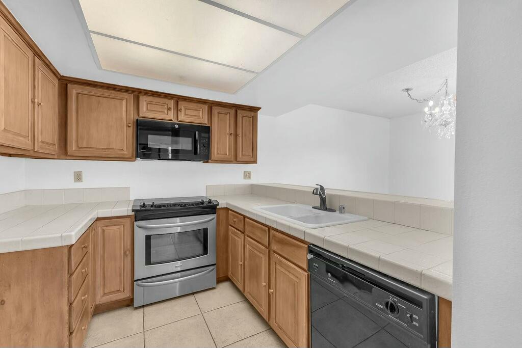 69527 Huerta Court Rancho Mirage, CA 92270 - Photo 8 of 22 a kitchen with a sink stove and microwave