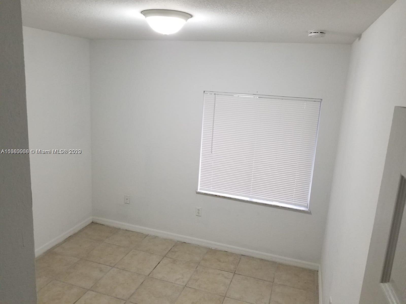 13622 Southwest 285th Terrace Homestead, FL 33033 - Photo 21 of 28 an empty room with a window