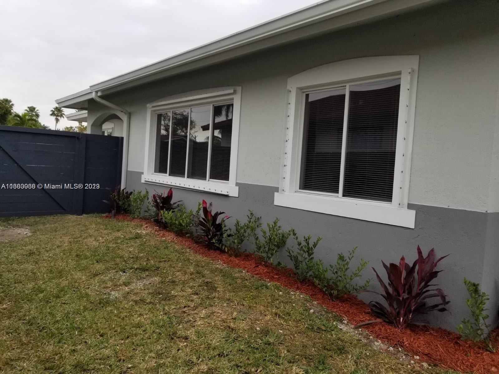 13622 Southwest 285th Terrace Homestead, FL 33033 - Photo 6 of 28 a front view of a house with a garden