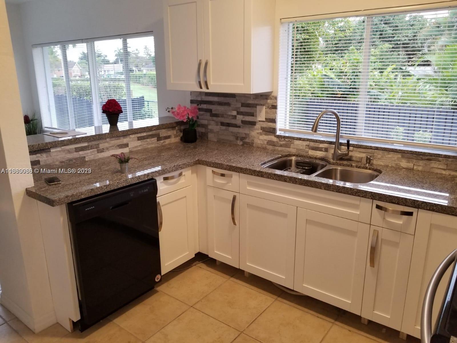 13622 Southwest 285th Terrace Homestead, FL 33033 - Photo 9 of 28 a kitchen with granite countertop a sink and a window