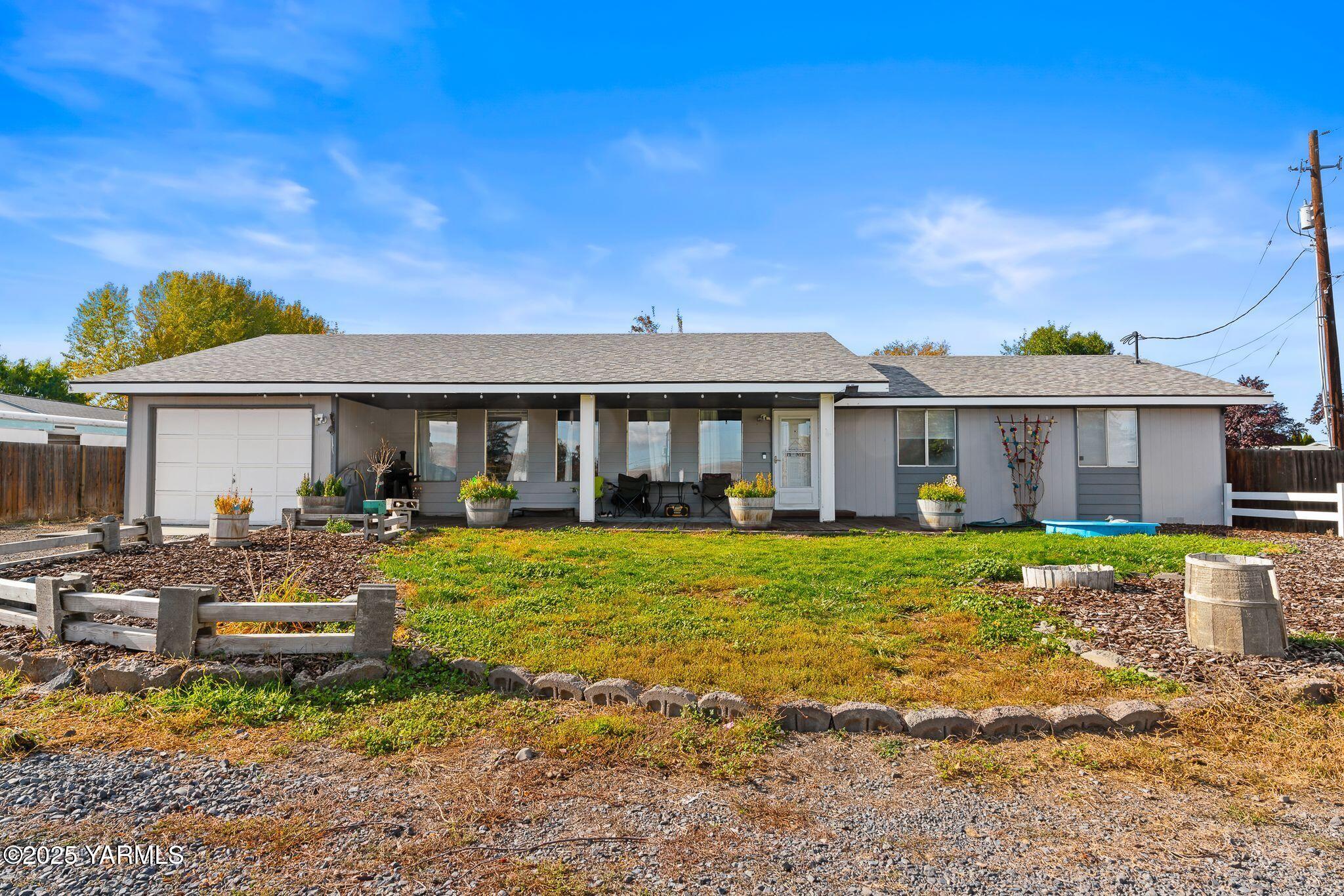 1620 Selah Loop Road Selah, WA 98942 - Photo 1 of 33 a front view of a house with a yard table and chairs