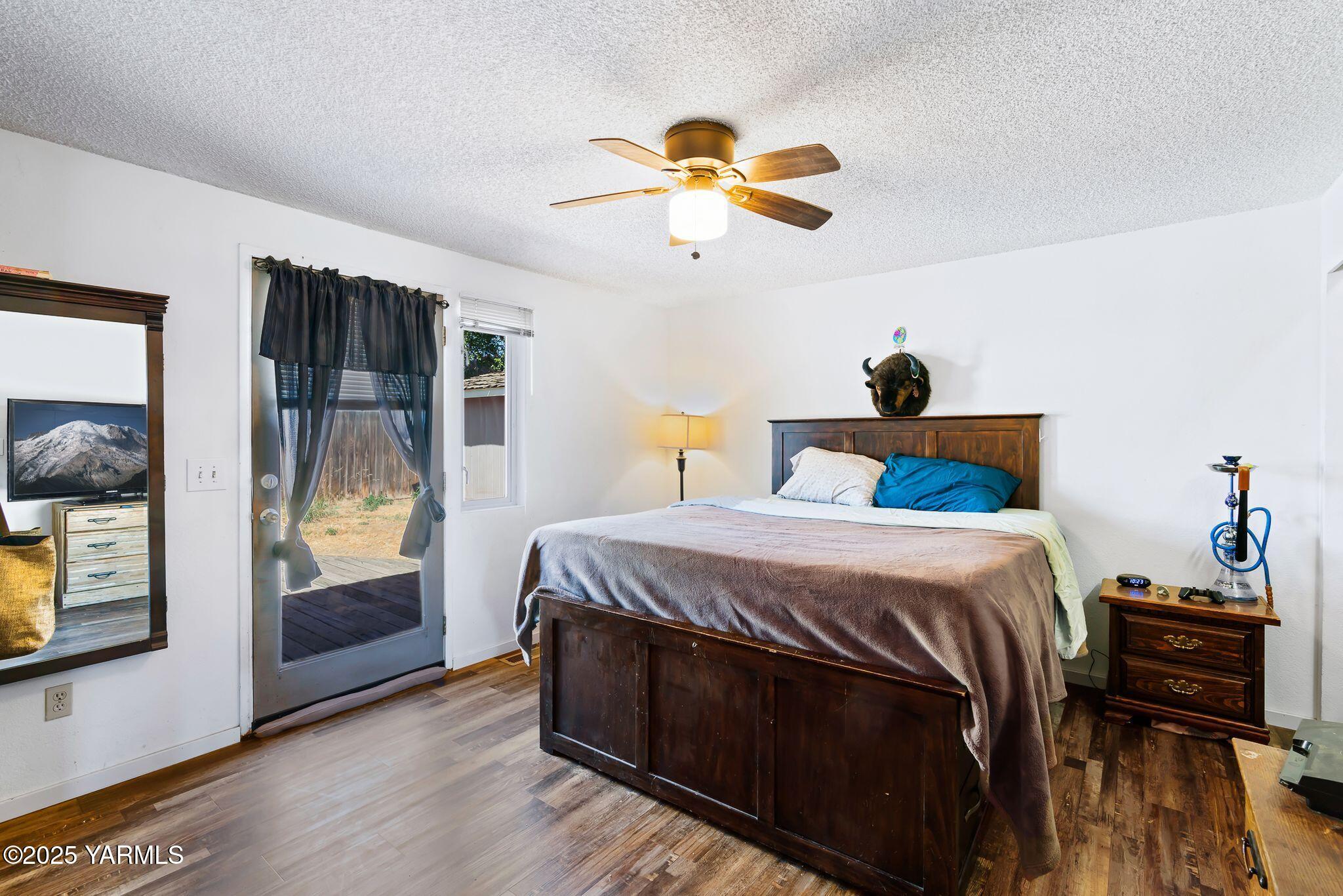 1620 Selah Loop Road Selah, WA 98942 - Photo 16 of 33 a bedroom with a bed and wooden floor