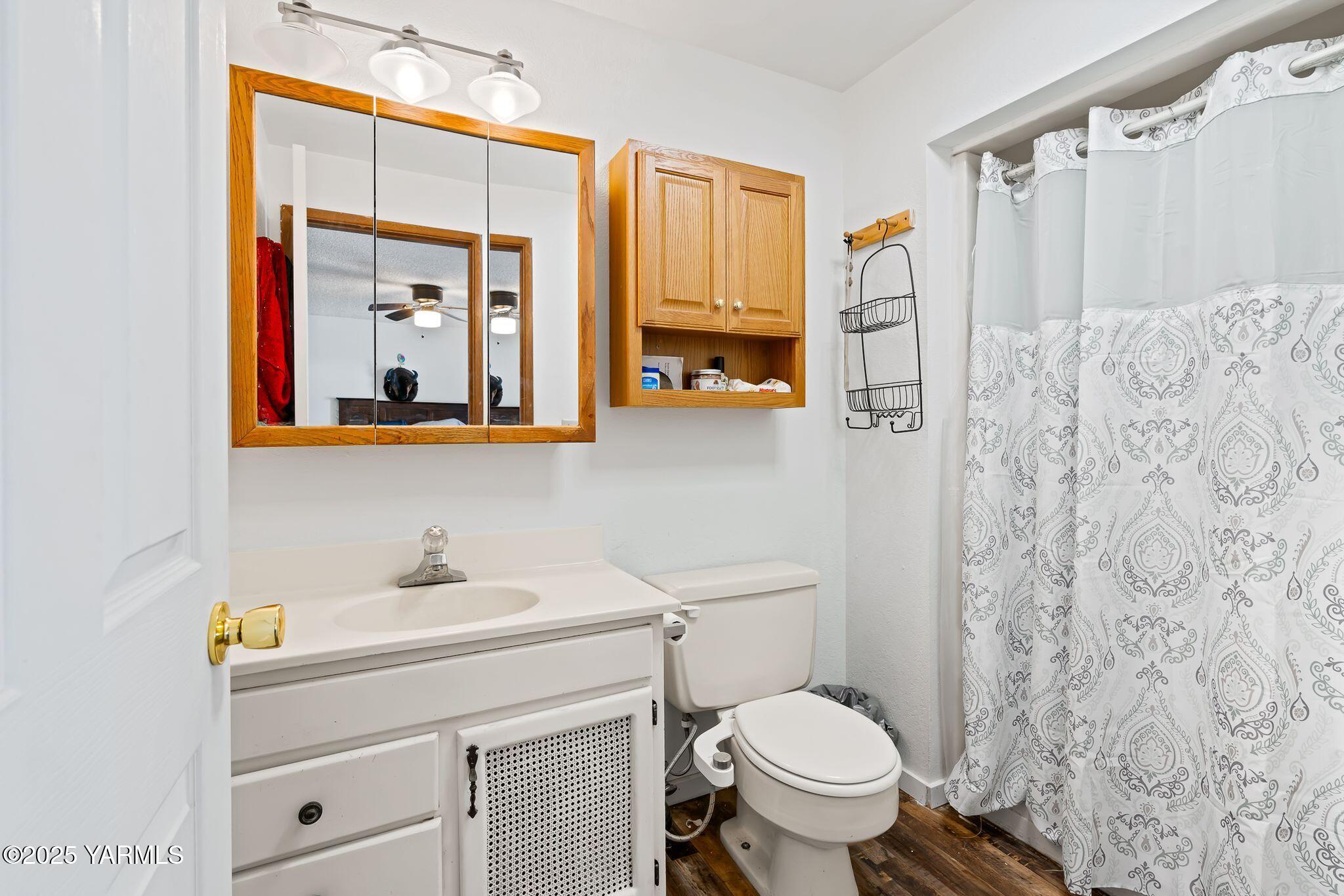 1620 Selah Loop Road Selah, WA 98942 - Photo 18 of 33 a bathroom with a sink a toilet and shower curtain