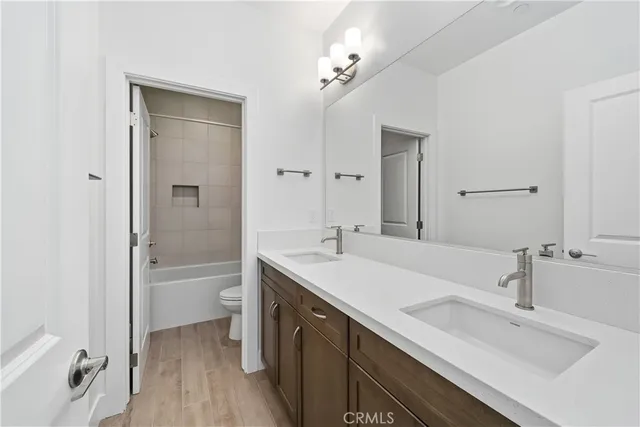 a bathroom with a tub a sink and mirror