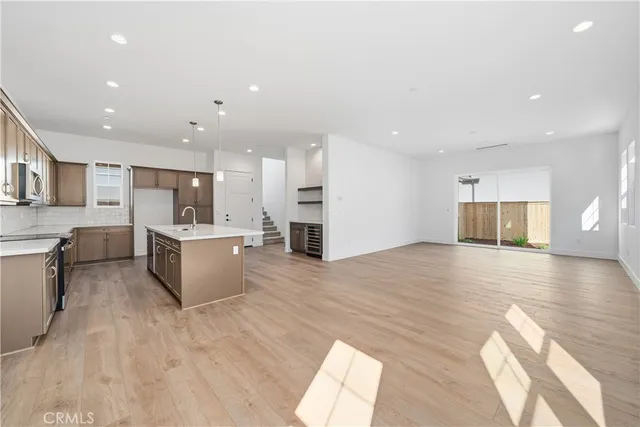 a large kitchen with a large counter top appliances and cabinets