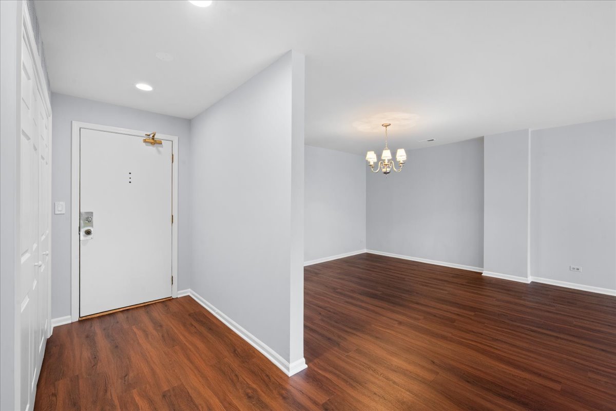 1795 Lake Cook Road, Unit 107 Highland Park, IL 60035 - Photo 4 of 26 a view of empty room with wooden floor