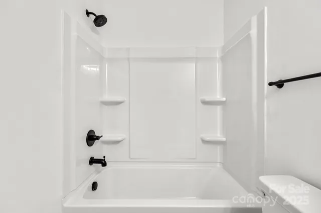 a bathroom with a bathtub and shower