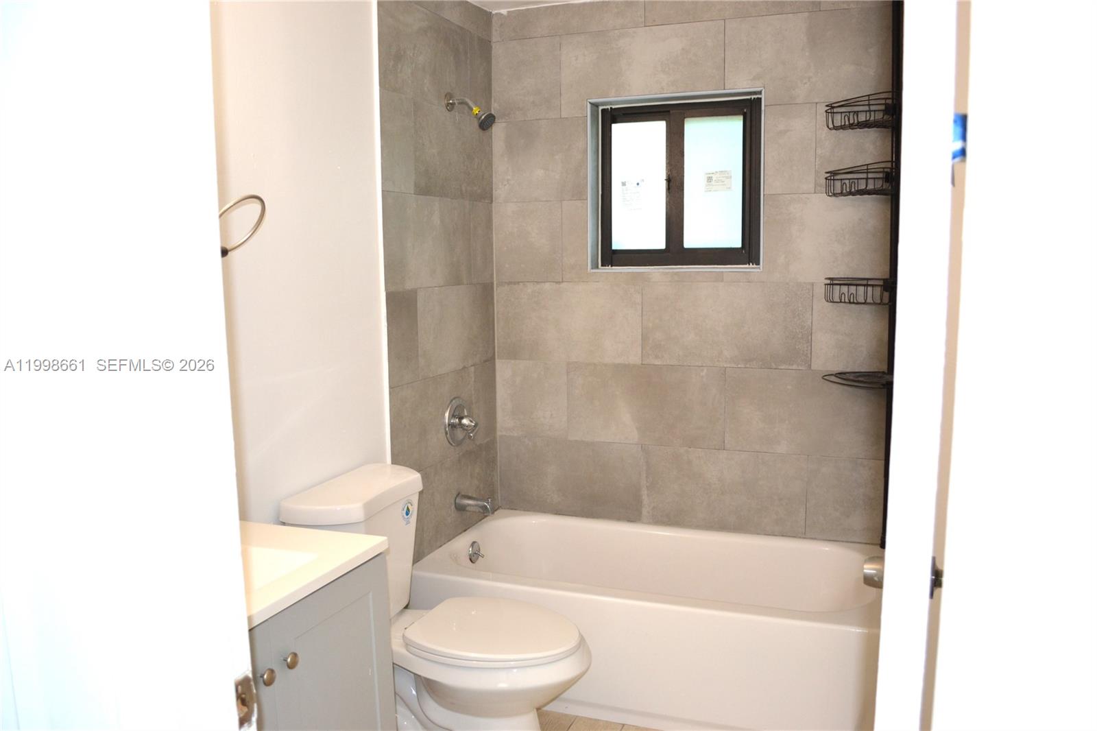 1037 Southwest 4th Street, Unit 4 Miami, FL 33130 - Photo 8 of 12 a bathroom with a toilet and a bathtub