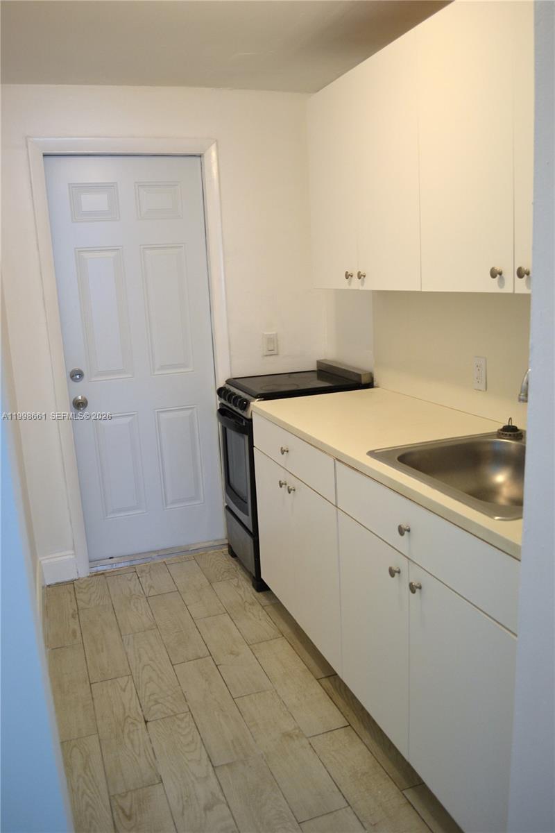 1037 Southwest 4th Street, Unit 4 Miami, FL 33130 - Photo 10 of 12 a utility room with cabinets washer and dryer