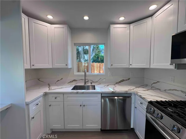 a kitchen with a sink stove and cabinets