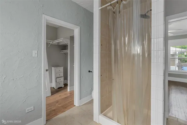 a view of a bathroom from a corridor