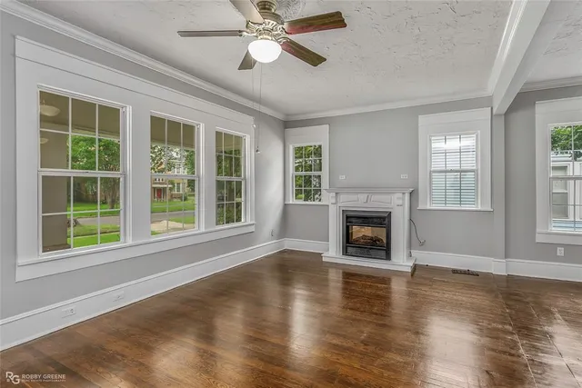 a view of an empty room with window and fire place