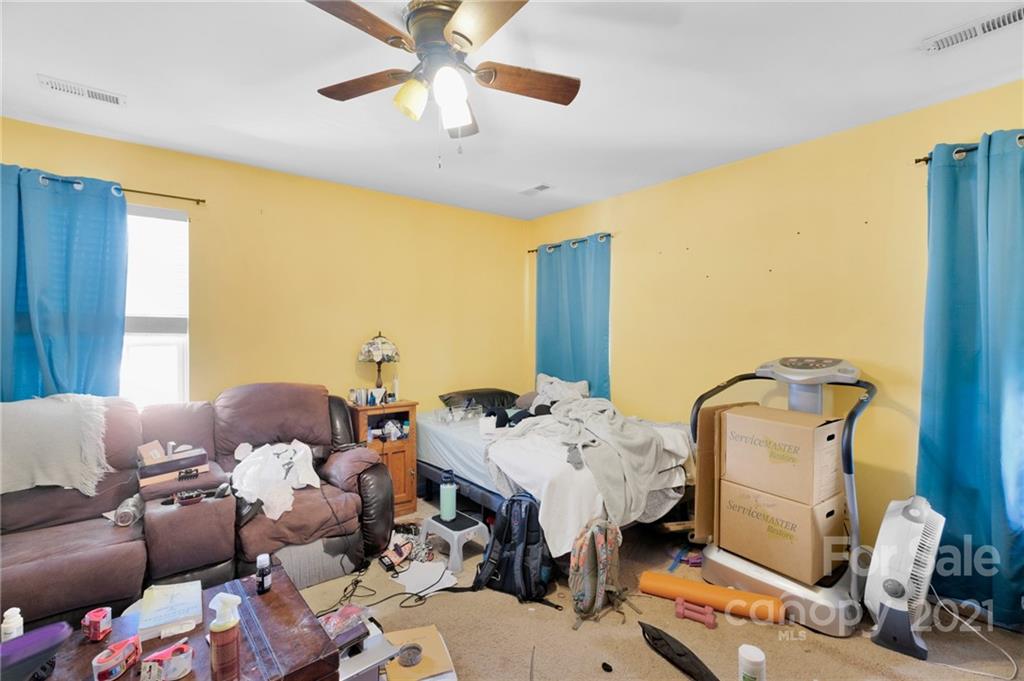 3800 Ruth Street Indian Trail, NC 28079 - Photo 18 of 34 a bedroom with furniture and a chandelier
