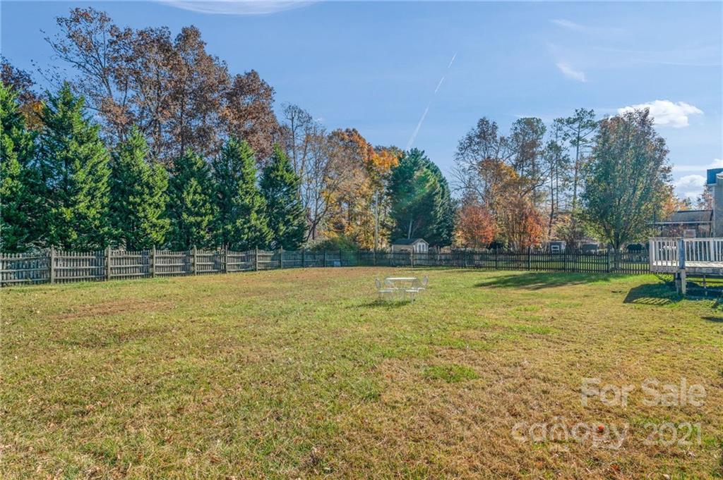 3800 Ruth Street Indian Trail, NC 28079 - Photo 26 of 34 a view of a swimming pool and trees in the background