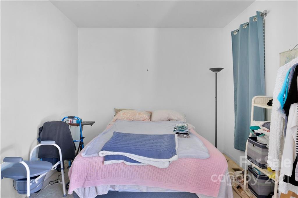 3800 Ruth Street Indian Trail, NC 28079 - Photo 5 of 34 a bedroom with a bed and a chandelier