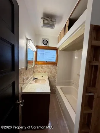 a bathroom with a sink a toilet and a bathtub