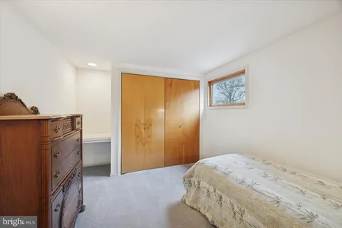 a bedroom with a bed and cabinets