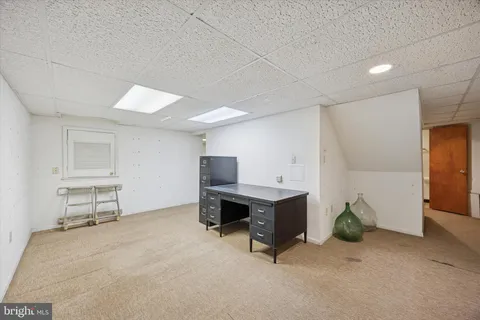 a view of a workspace with furniture and a workspace