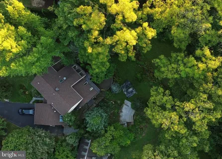 an aerial view of a house with a yard