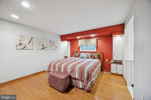 a bedroom with a large bed and a window