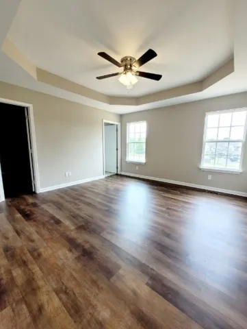 a view of a livingroom with a ceiling fan and window