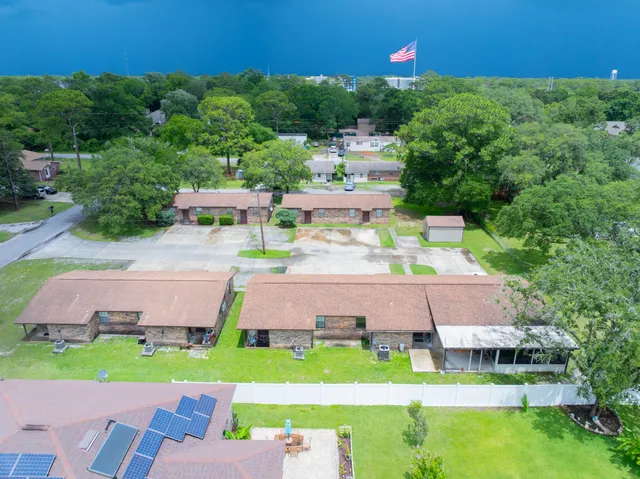 an aerial view of a house with a garden and swimming pool