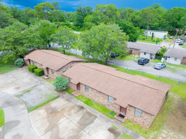 an aerial view of a house with a yard basket ball court and outdoor seating