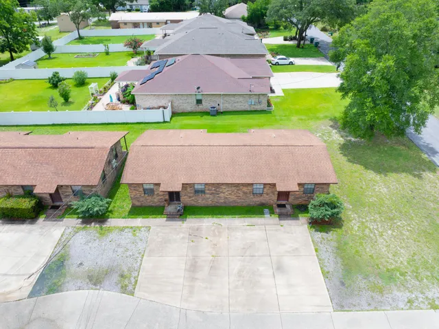 a aerial view of a house with a yard and lake view
