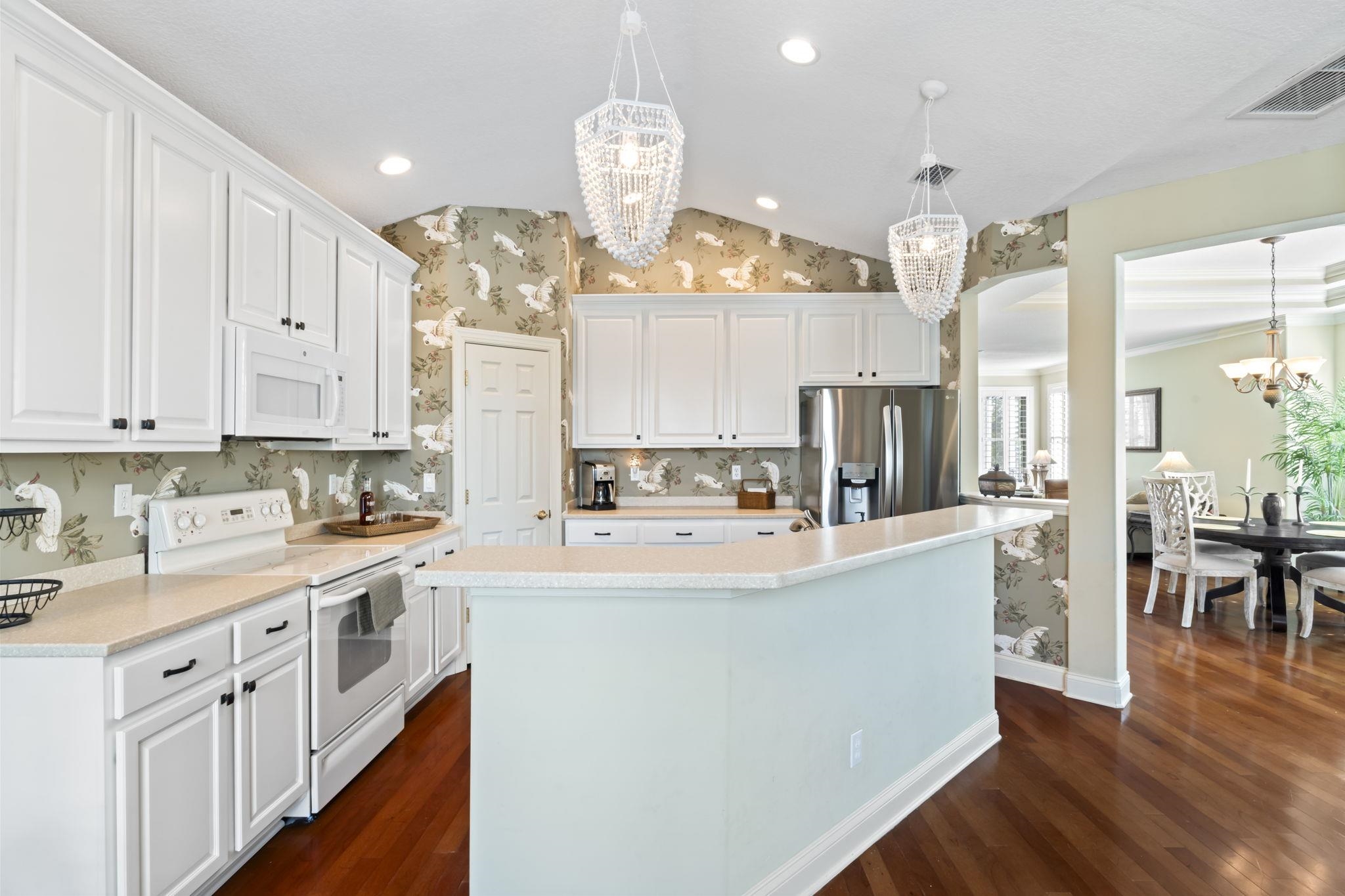 103 Sunset Circle South St. Augustine, FL 32080 - Photo 11 of 55 a large kitchen with stainless steel appliances lots of counter space and wooden floor