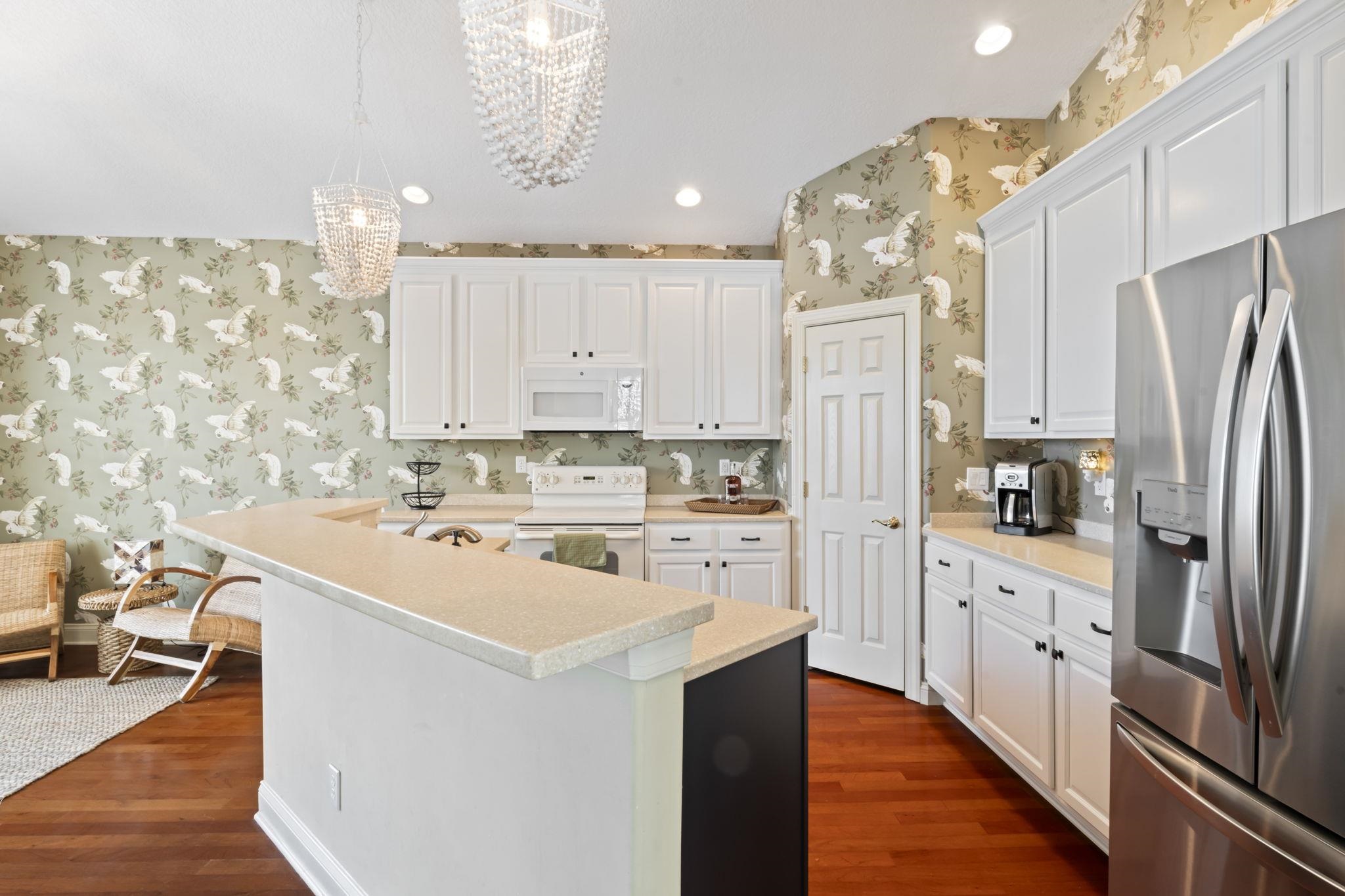 103 Sunset Circle South St. Augustine, FL 32080 - Photo 12 of 55 a kitchen with stainless steel appliances a stove refrigerator sink and cabinets