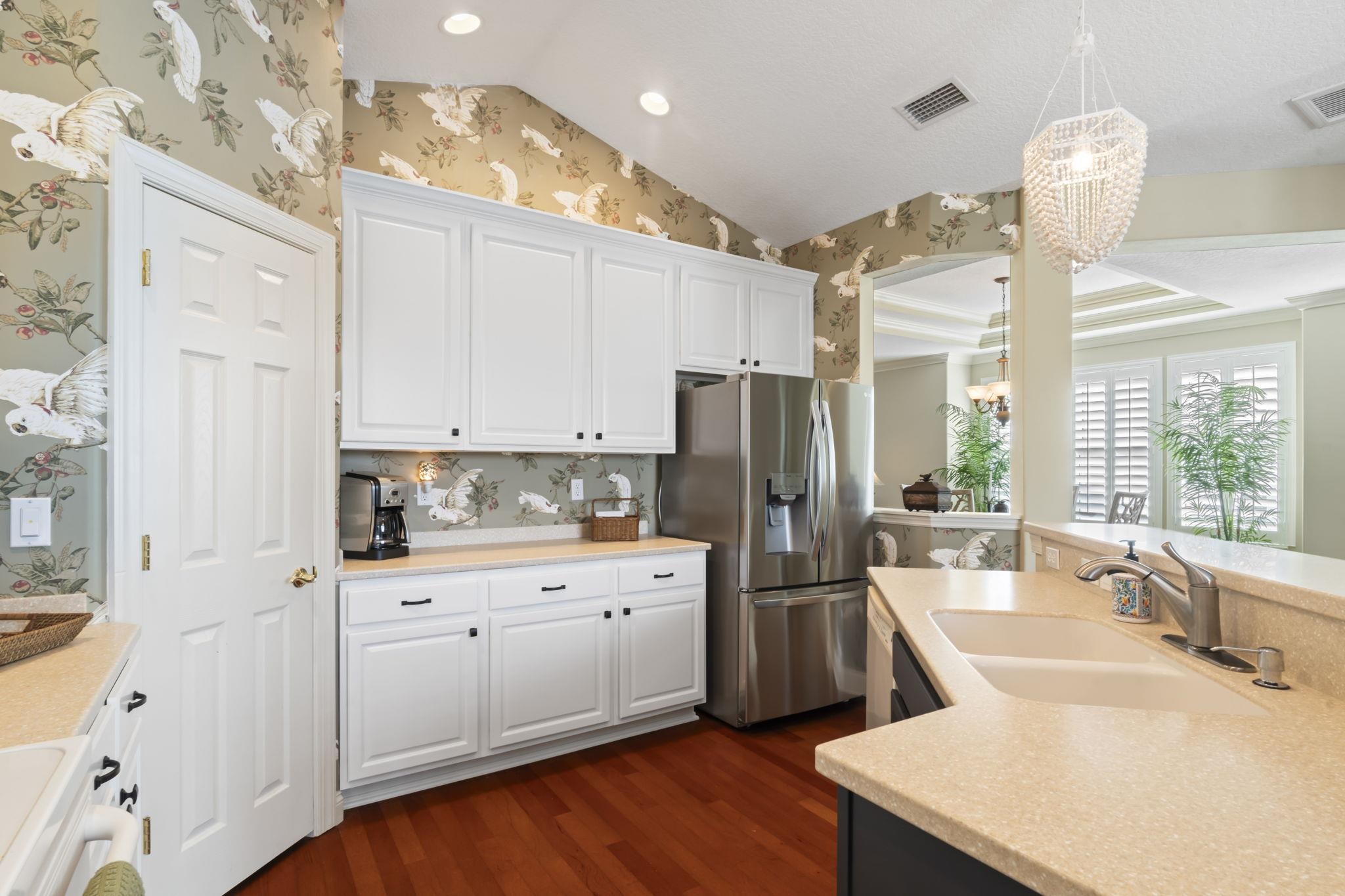 103 Sunset Circle South St. Augustine, FL 32080 - Photo 15 of 55 a kitchen with white cabinets and stainless steel appliances
