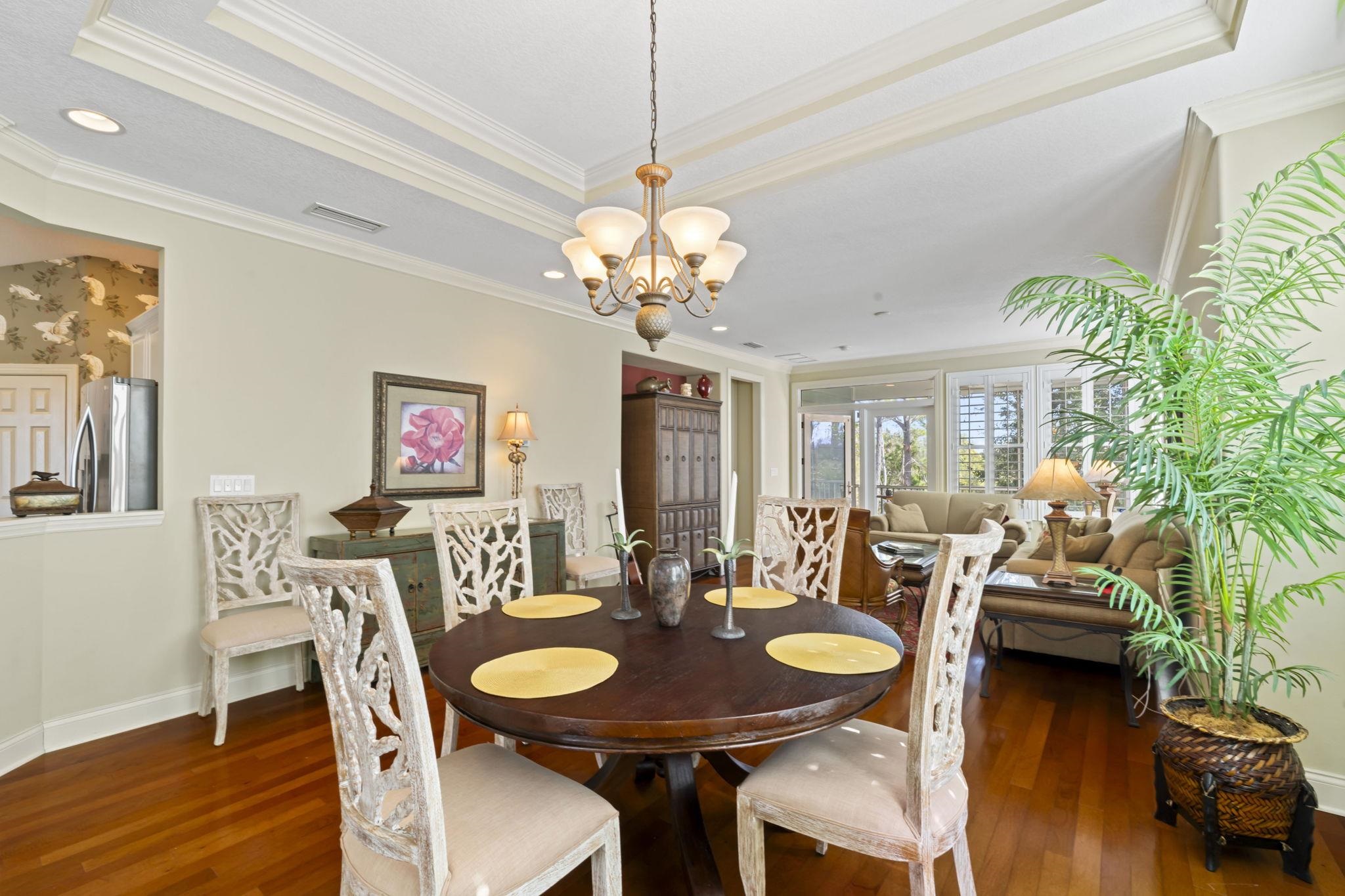 103 Sunset Circle South St. Augustine, FL 32080 - Photo 18 of 55 a view of a dining room with furniture wooden floor and chandelier