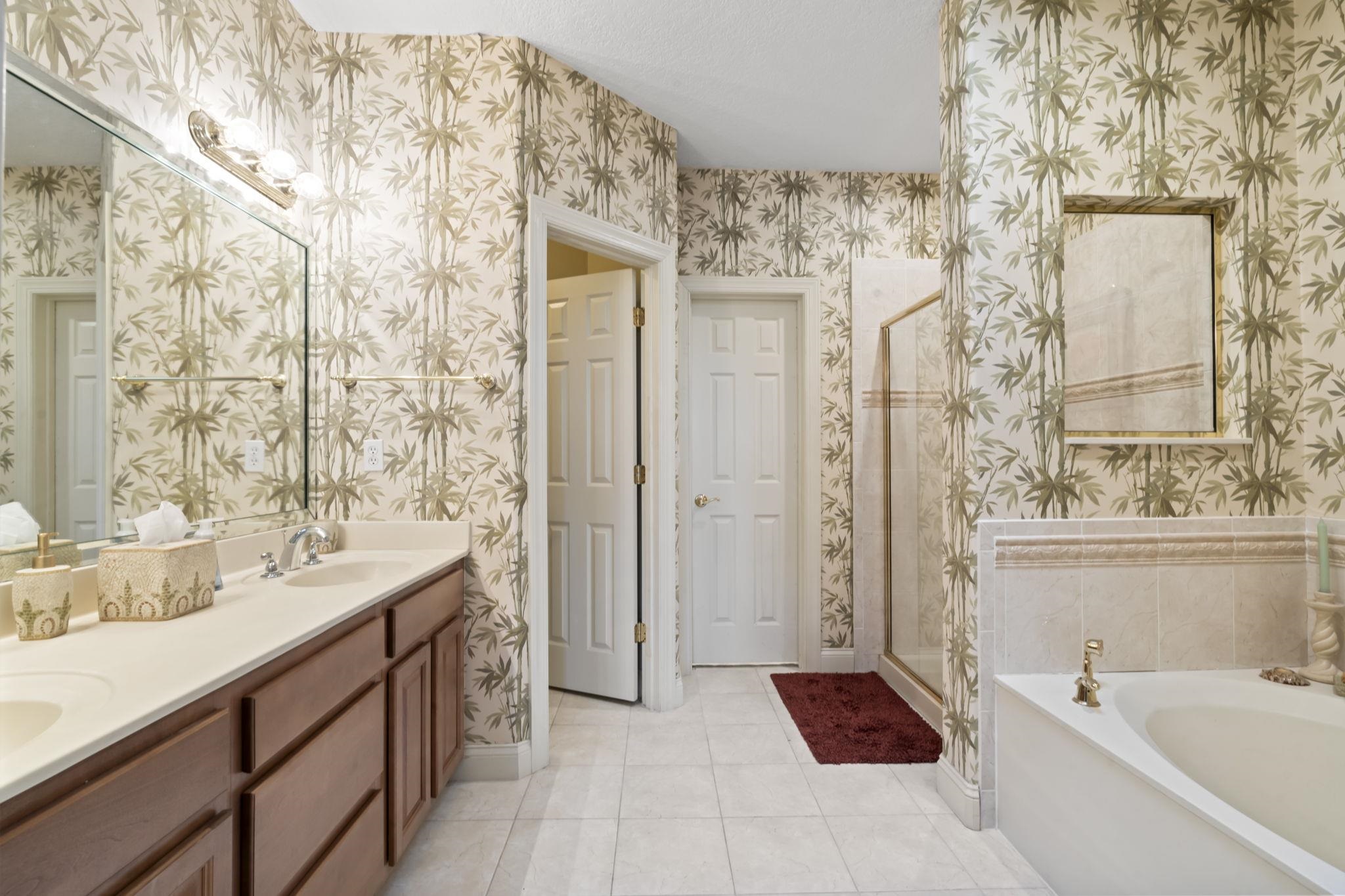 103 Sunset Circle South St. Augustine, FL 32080 - Photo 29 of 55 a bathroom with a double vanity sink a large mirror and a bathtub