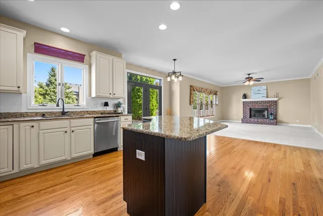 a kitchen with sink cabinets and wooden floor