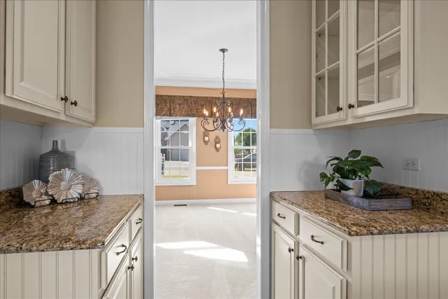 a kitchen with a granite countertop sink and cabinets