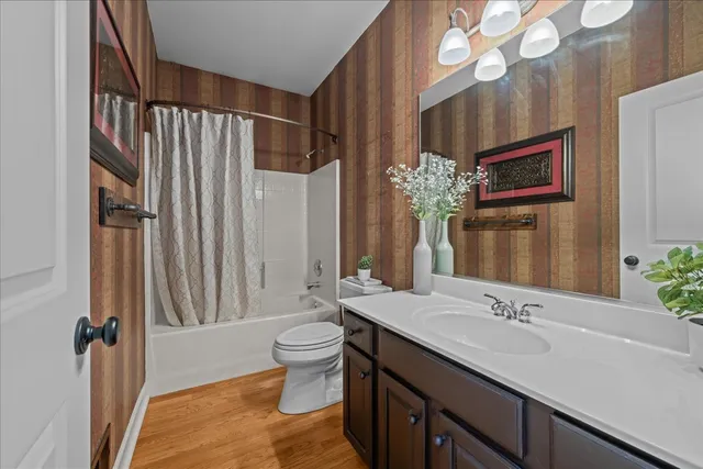 a bathroom with a double vanity sink mirror and toilet