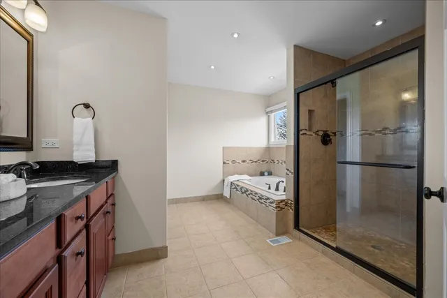 a bathroom with a granite countertop sink mirror and shower