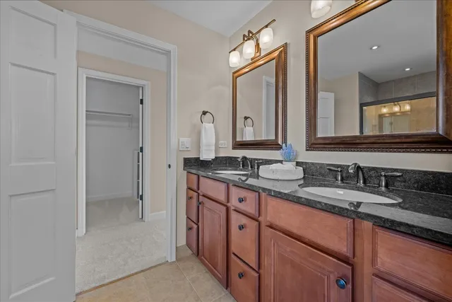 a bathroom with double sink and a mirror
