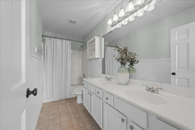 a spacious bathroom with a double vanity sink and a mirror