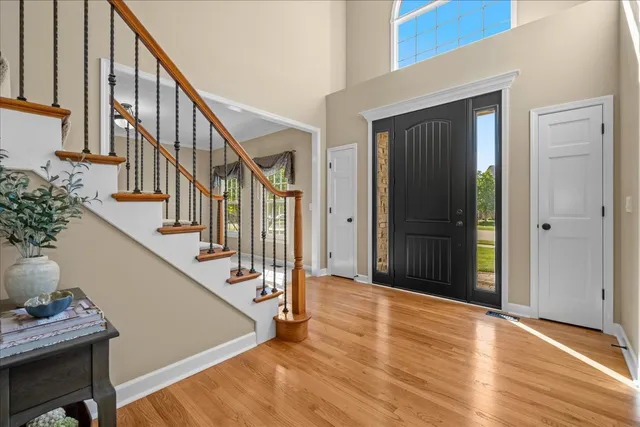 a view of entryway with wooden floor and stairs