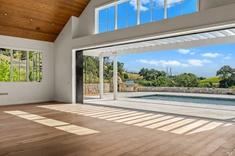 a view of a room with wooden floor and a window