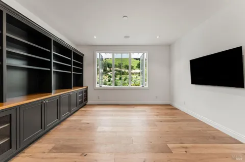 a view of a room with wooden floor and window