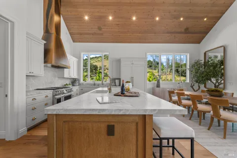 a kitchen with kitchen island a sink stove and cabinets