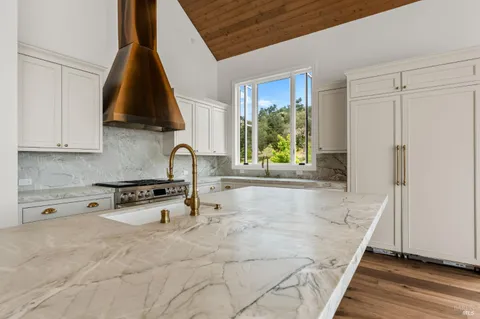 a kitchen with granite countertop a sink and a stove